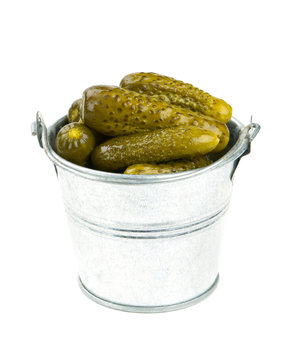 pickled cucumbers in a metal bucket isolated on white