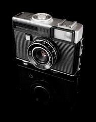 old camera on black background - obrazy, fototapety, plakaty