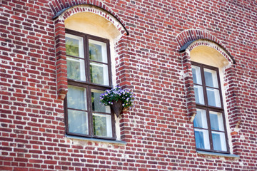 two windows in a red brick wall