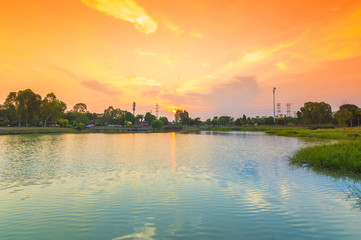 Fototapeta premium Sunset with blue lake garden