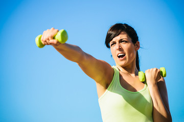 Fitness woman boxing with dumbbells