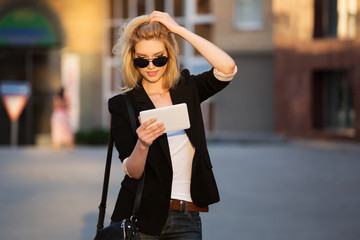 Fototapeta premium Young business woman using a tablet computer