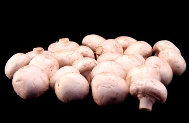 Champignons on black table.