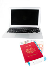 Passport with Philippine currency and laptop