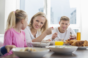 Obraz na płótnie Canvas Happy family with children having breakfast at table