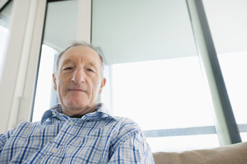 Portrait of senior man relaxing in living room