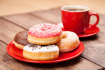 Tasty donut with a cup of coffee