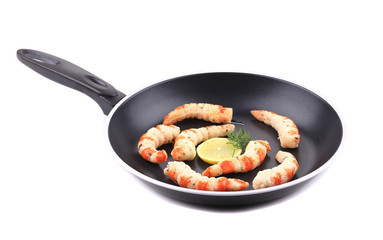 Cooked unshelled shrimp on frying pan.