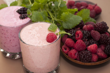 Yogurt with raspberries and blackberries and sprigs of mint .