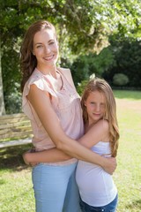 Fototapeta premium Woman embracing her daughter at park