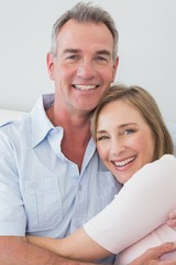 Obraz na płótnie Canvas Portrait of a happy couple embracing at home
