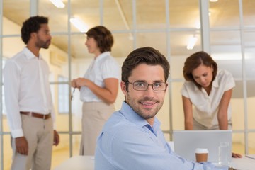 Smiling businessman with colleagues in meeting