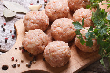raw meatballs on a chopping board view from above.
