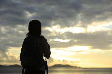 Fototapeta premium woman hiker enjoy the view at sunrise seaside
