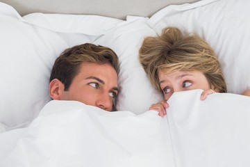Relaxed young couple in bed
