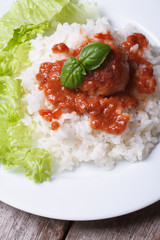 meatballs with tomato sauce and rice on the table. top view