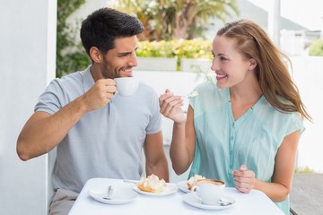 Obraz na płótnie Canvas Portrait of a happy couple at coffee shop