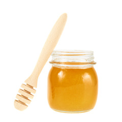 Honey dipper next to a jar