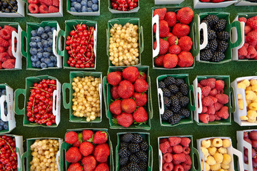 Currants strawberries blackberries raspberries in little boxes