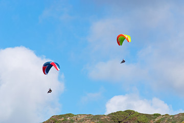 two para gliders on a cloudy day