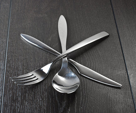 Three kitchen utensils on the wooden table