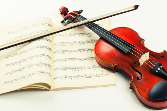 Vintage violin on sheet music background