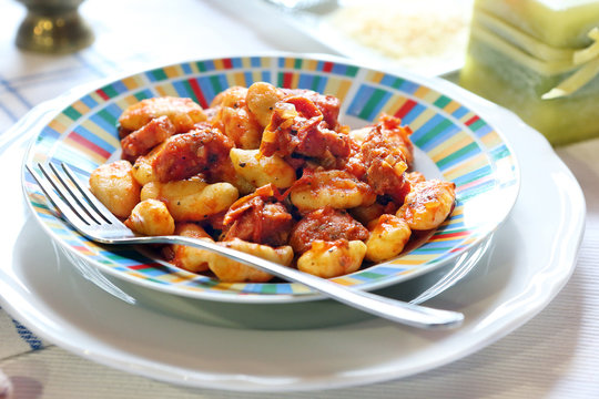 Gnocchi with tomato sauce, herbs and bacon