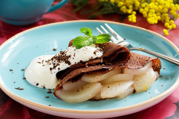 Chocolate pancakes with pears.