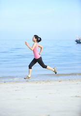 fitness  young woman running seaside  beach