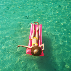 Woman relaxing on inflatable mattress