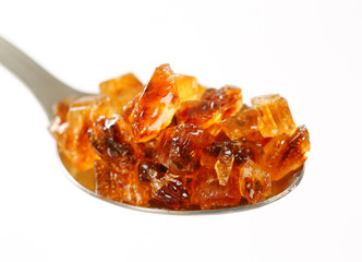 Brown rock sugar on spoon
