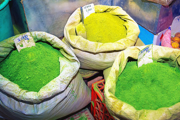 Green henna powder in bags, on souk market in Muscat, Oman