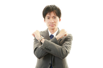 禁止の意思表示をするビジネスマン