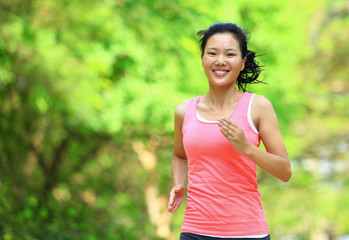 Fototapeta premium fitness woman runner running at park