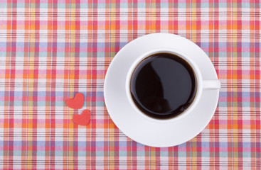 Cup of coffee and two hearts.