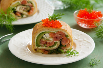roll pancakes with red fish and avocados.