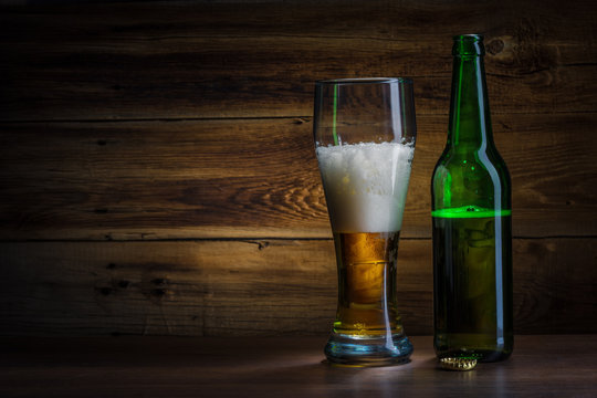 beer glass and bottle on a wooden background