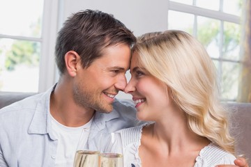 Loving couple with champagne flutes at home