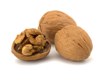 whole and cracked walnut isolated on the white background