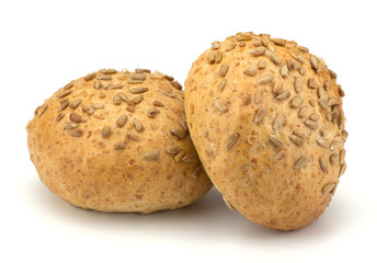 Round sandwich bun with sunflower seeds isolated on white backgr