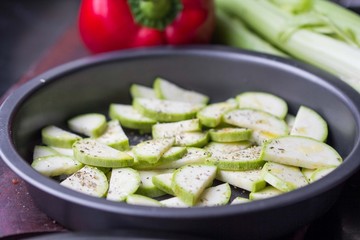 Fresh sliced zucchini with herb in form for baking, delicious