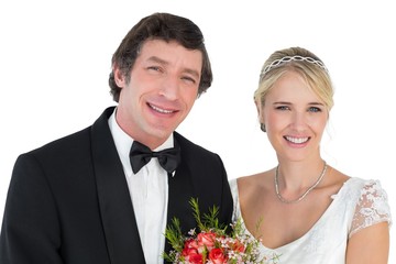 Newly wed couple smiling over white background