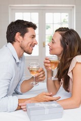 Loving couple with wine glasses looking at each other