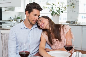 Loving couple with wine glasses at home