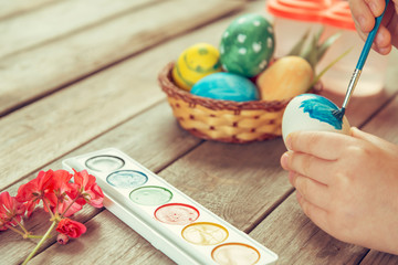 Girl paints Easter egg