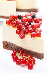 piece of cheesecake decorated with red and black currant
