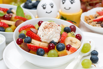 Fresh fruit salad with whipped cream and painted eggs