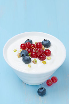 fresh sweet yogurt with berries and pistachios
