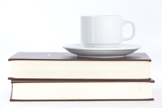 Composition with books and cup of coffee isolated on white