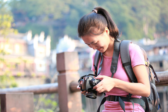 woman tourist taking photo with digital camera